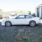 Nissan Silvia S14 left view – OEM taillights, aftermarket exhaust, visible body prep work