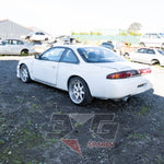 Nissan Silvia S14 rear-left view – OEM taillights, aftermarket exhaust, visible body prep work