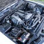 S14 SR20DE engine – left-side view showing intake manifold, fuse box, and battery mount