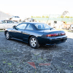 Rear-left angle of Nissan Silvia S14 1.5 showing boot, taillights, and factory bumper