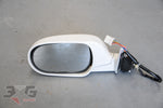 Used OEM Nissan R33 Skyline sedan left door mirror 96302‑15U01 in QM1 Cloud White, good condition with original mounting bracket.