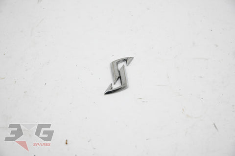 New OEM Nissan "S" hood emblem 65892‑AA000 – fits R34 Skyline