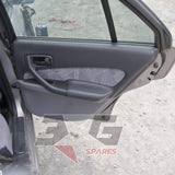 Nissan HR34 Skyline GT rear door trim card — factory cloth insert and interior handle