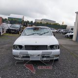 1997 Nissan Laurel HC34 Medalist front view showing overall condition in yard, white exterior — 3GSpares NZ