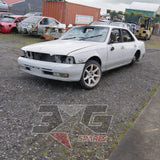 1997 Nissan Laurel HC34 Medalist front three-quarter passenger side, aftermarket white alloy on front right  — 3GSpares NZ