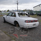 1997 Nissan Laurel HC34 Medalist rear three-quarter passenger side, roof damage and rear glass missing, damaged tail lights — 3GSpares NZ