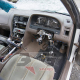 1997 Nissan Laurel HC34 Medalist driver's side interior showing stripped steering column, instrument cluster,manual conversion — 3GSpares NZ