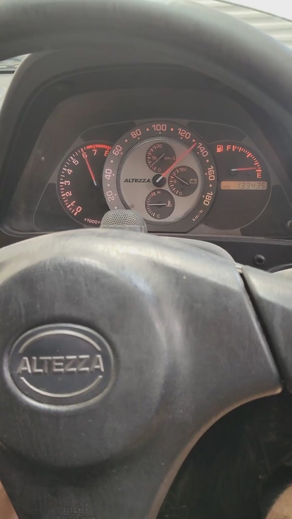 Close-up of Toyota GXE10 Altezza gauge cluster during a dyno gearbox test, showing precise shift points and RPM stability under load.